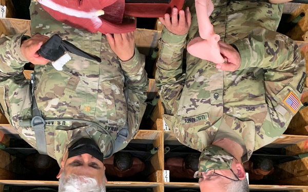 Soldiers from Medical Readiness Training Command prepare a cut-suit for use at Global Medic in Fort McCoy, Wisconsin
