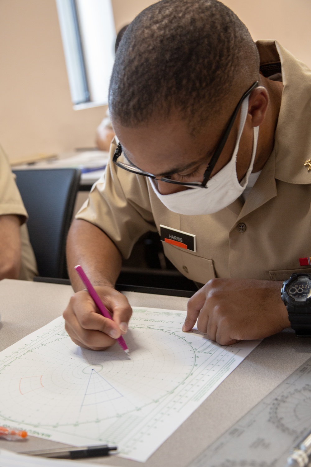 210810-N-YF306-0058 NEWPORT, R.I (Aug. 10, 2021) Officer Candidate Plots Point During Class