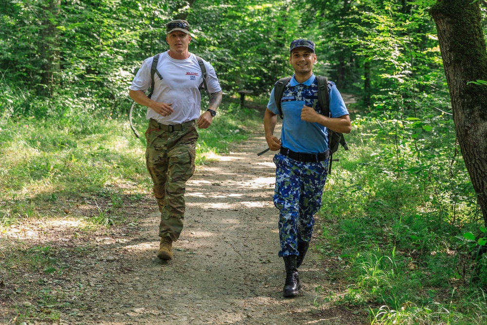 Sgt. 1st Class Shane Price runs alongside a Romanian Air Defense Reserve Soldier