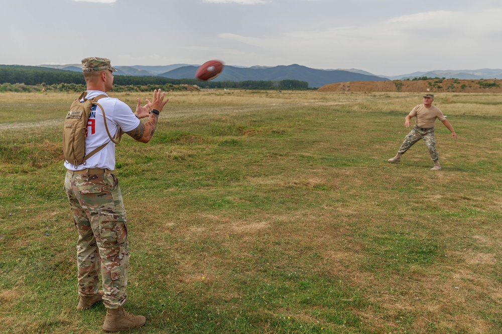 Staff Sgt. Devin Crawford catches a football from a Romanian Reserve Soldier