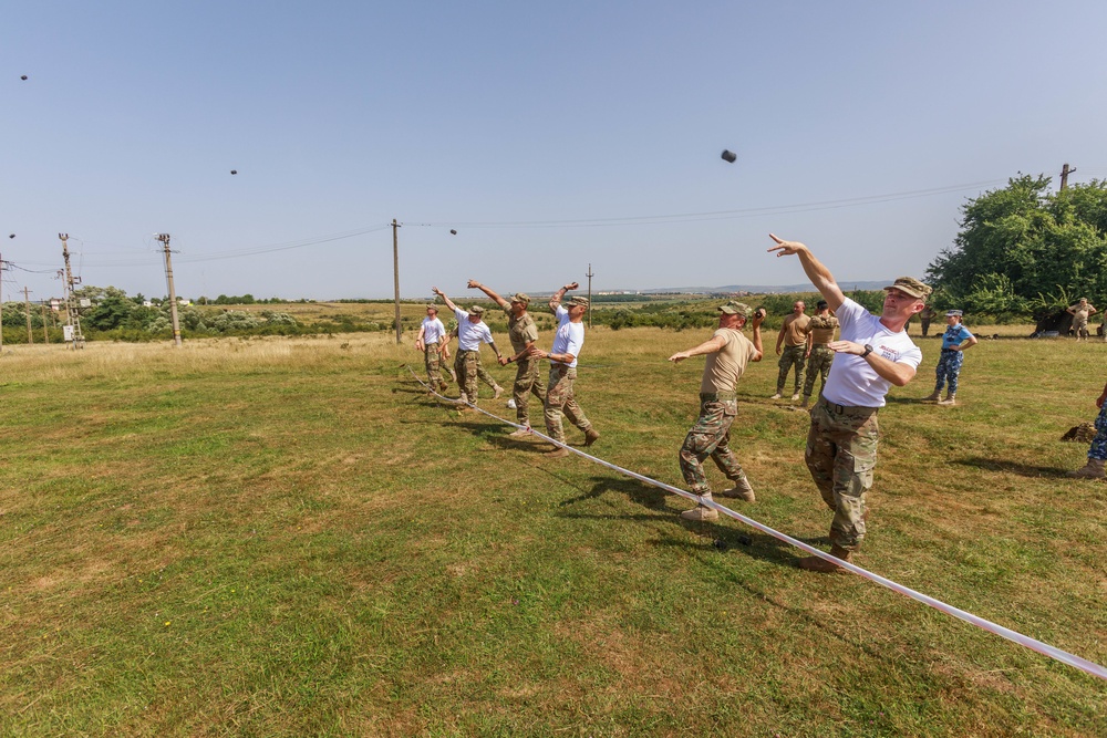 American and Romanian reserve service members throw practice grenades