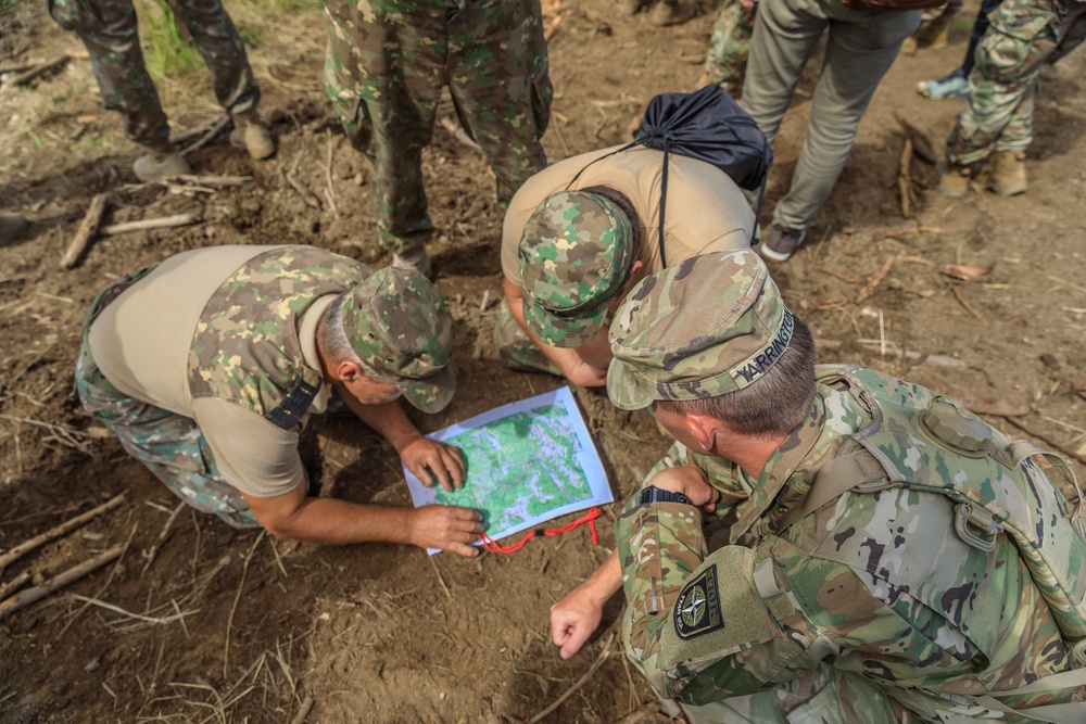 American and Romanian reserve service members practice map reading