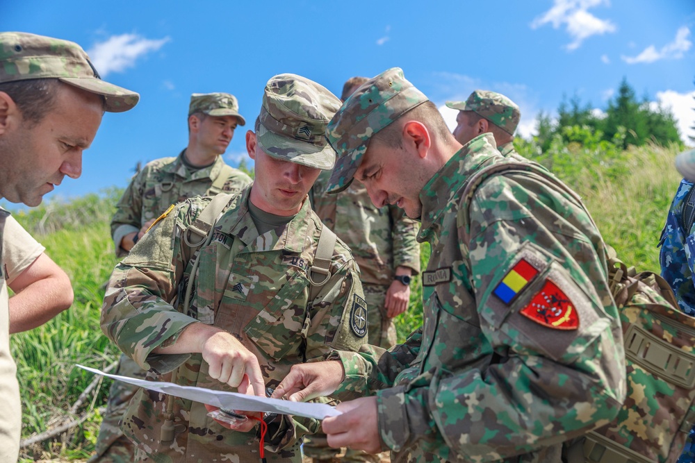 Sgt. Michael Yarrington points to a map