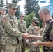 Sgt. Morgan Figgs receives a patch from Lt. Gen. (Ret.) Virgil Balaceanu