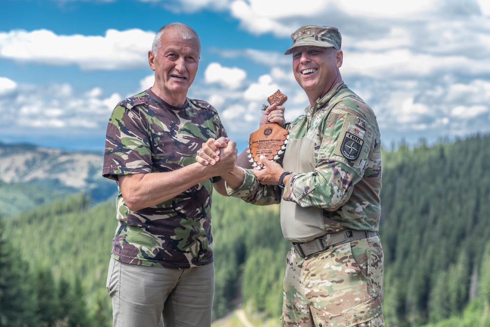 Col. Joel Whinton gives a small token of appreciation to Lt. Gen. (Ret.) Virgil Balaceanu