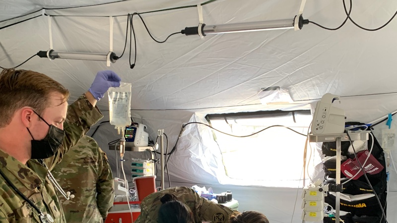 Medics work to stabilize a simulated combat casualty at Global Medic 21-02