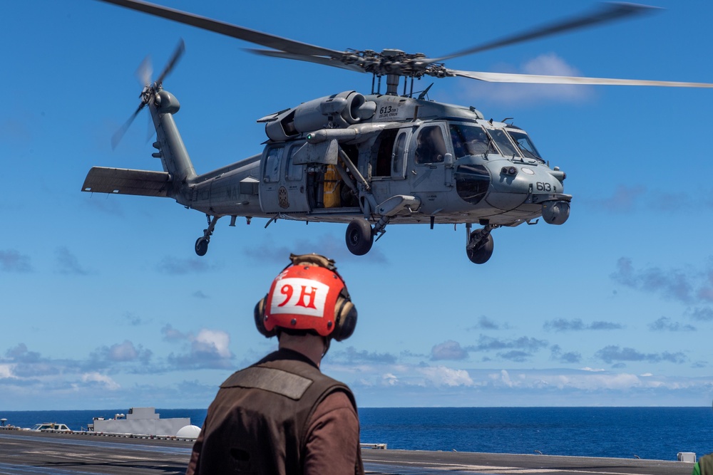 USS Carl Vinson (CVN 70) helicopter takes off flight deck