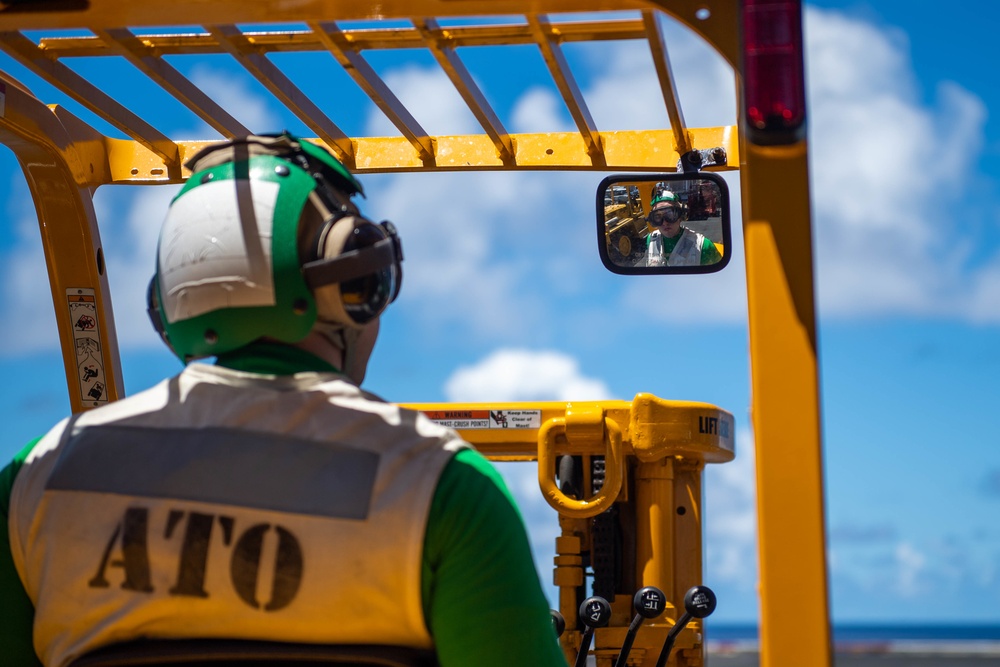 USS Carl Vinson (CVN 70) Sailor operates forklift