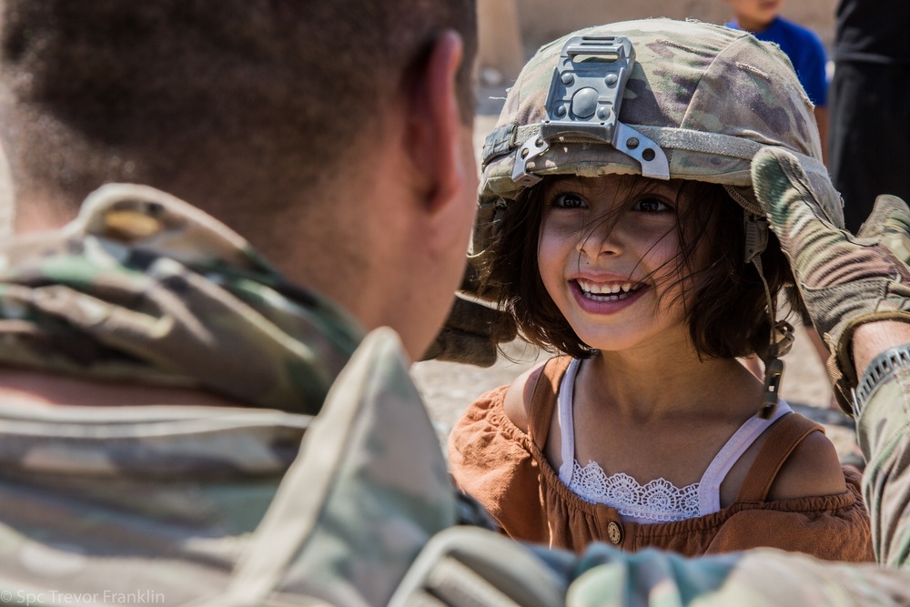 Happy child meets U.S. Troops