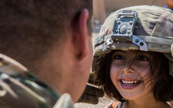 Happy child meets U.S. Troops