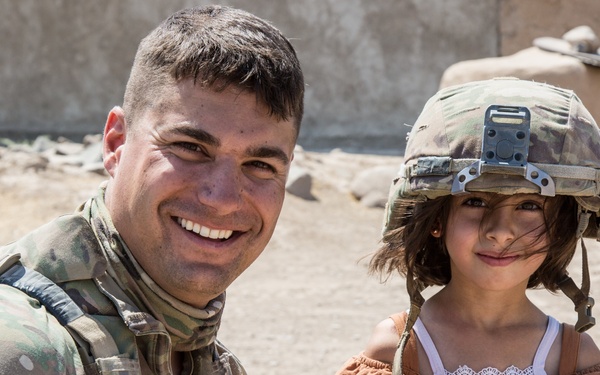 Happy child meets U.S. Troops