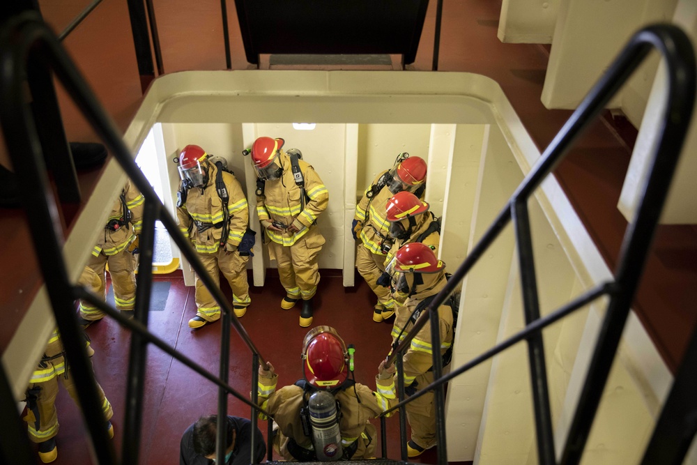 USS Miguel Keith (ESB 5) Sailors participate in firefighting debreif