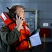 Lt. Cmdr. Doug Stahl uses a satellite phone during a man overboard drill on USS Miguel Keith