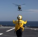 Aviation Boatswain’s Mate 3rd Class Nadezhda Zurbriggen directs an MH-60S Sea Hawk from Helicopter Sea Combat Squadron (HSC) 23 aboard expeditionary sea base USS Miguel Keith (ESB 5)