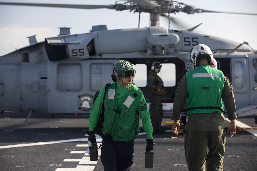 Sailors assigned to Helicopter Sea Combat Squadron (HSC) 23 offload an MH-60S Sea Hawk aboard expeditionary sea base USS Miguel Keith (ESB 5)