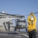 Aviation Boatswain’s Mate 3rd Class Nadezhda Zurbriggen directs an MH-60S Sea Hawk from Helicopter Sea Combat Squadron (HSC) 23 aboard expeditionary sea base USS Miguel Keith (ESB 5)