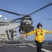 Aviation Boatswain’s Mate 3rd Class Nadezhda Zurbriggen directs an MH-60S Sea Hawk from Helicopter Sea Combat Squadron (HSC) 23 aboard expeditionary sea base USS Miguel Keith (ESB 5)