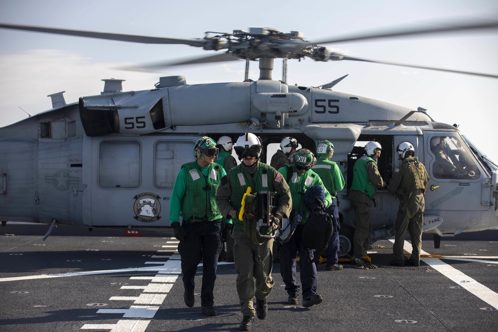 Sailors assigned to Helicopter Sea Combat Squadron (HSC) 23 offload an MH-60S Sea Hawk aboard expeditionary sea base USS Miguel Keith (ESB 5)