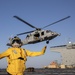 Aviation Boatswain’s Mate 3rd Class Nadezhda Zurbriggen directs an MH-60S Sea Hawk from Helicopter Sea Combat Squadron (HSC) 23 aboard expeditionary sea base USS Miguel Keith (ESB 5)