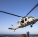 Aviation Boatswain’s Mate Airman Jacobi Easterling, left, and Airman Salva Kritzer attach cargo to an MH-60S Sea Hawk from Helicopter Sea Combat Squadron (HSC) 23 aboard expeditionary sea base USS Miguel Keith (ESB 5)