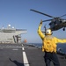 Aviation Boatswain’s Mate Airman Ethan Bowser directs an MH-60S Sea Hawk from Helicopter Sea Combat Squadron (HSC) 23 aboard expeditionary sea base USS Miguel Keith (ESB 5)