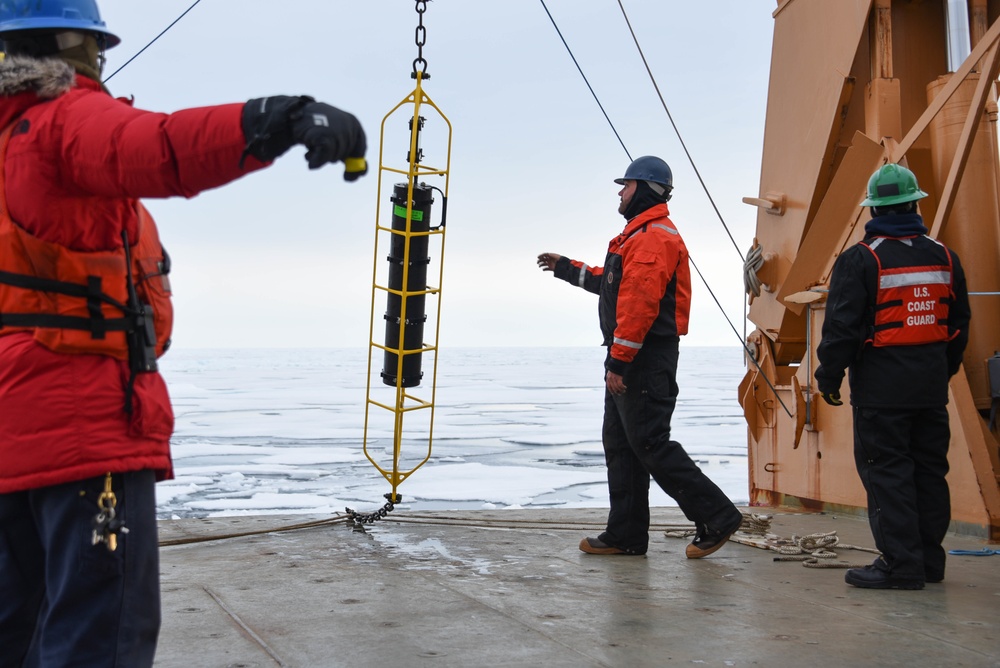 Coast Guard Cutter Healy crew members recover oceanographic research moorings