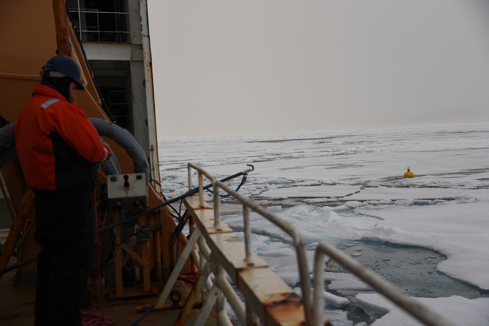 Coast Guard Cutter Healy crew members recover oceanographic research moorings