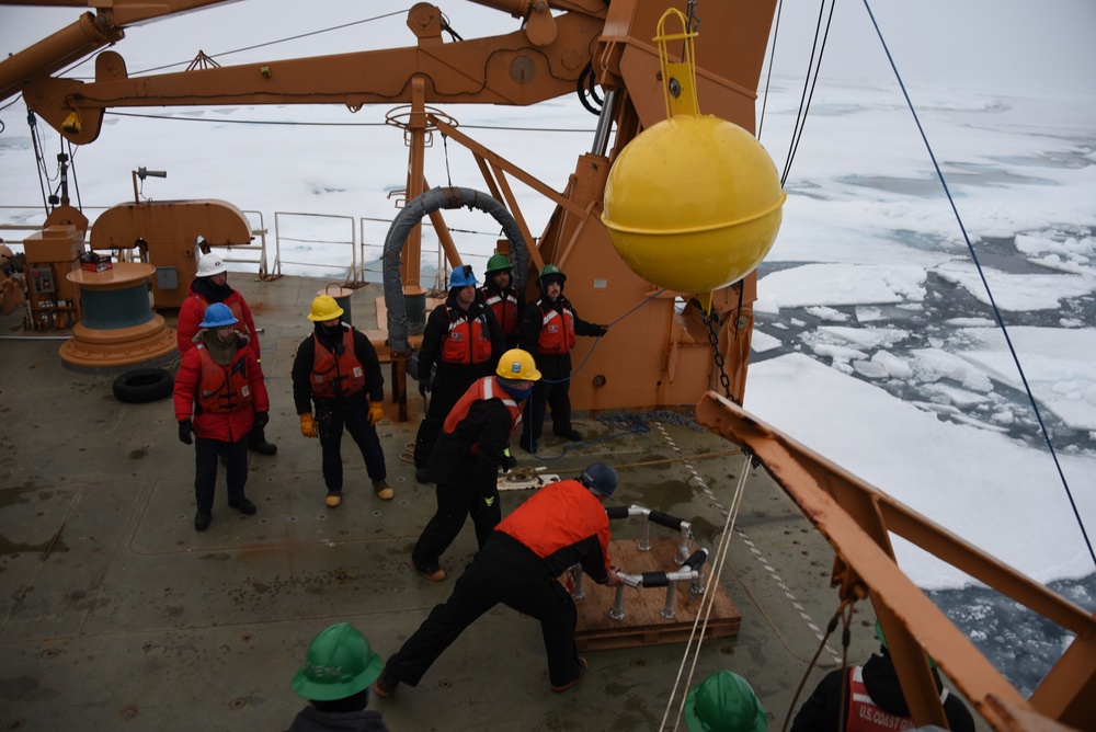 Coast Guard Cutter Healy crew members recover oceanographic research moorings