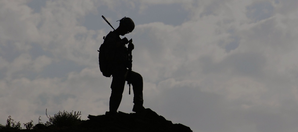 Soldier on Afghan hill