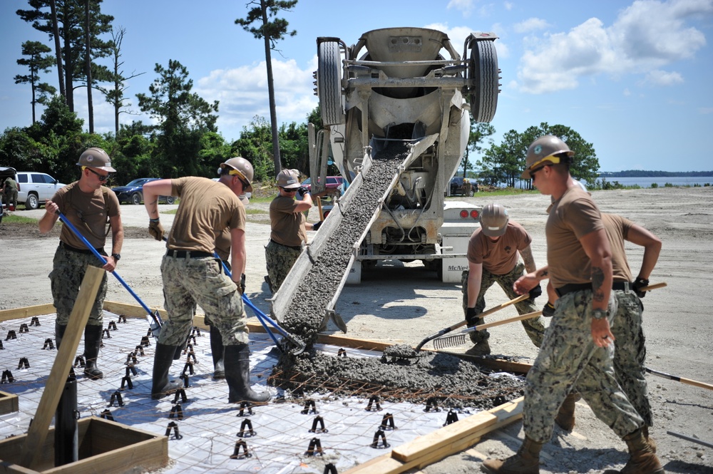 Seabees and Marines place two concrete pads on board Marine Corps Base Camp Lejeune, NC