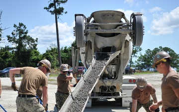 Seabees and Marines place two concrete pads on board Marine Corps Base Camp Lejeune, NC