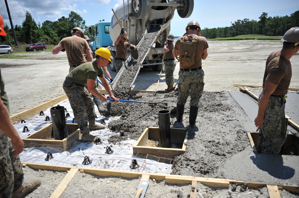 Seabees and Marines place two concrete pads on board Marine Corps Base Camp Lejeune, NC