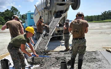 Seabees and Marines place two concrete pads on board Marine Corps Base Camp Lejeune, NC