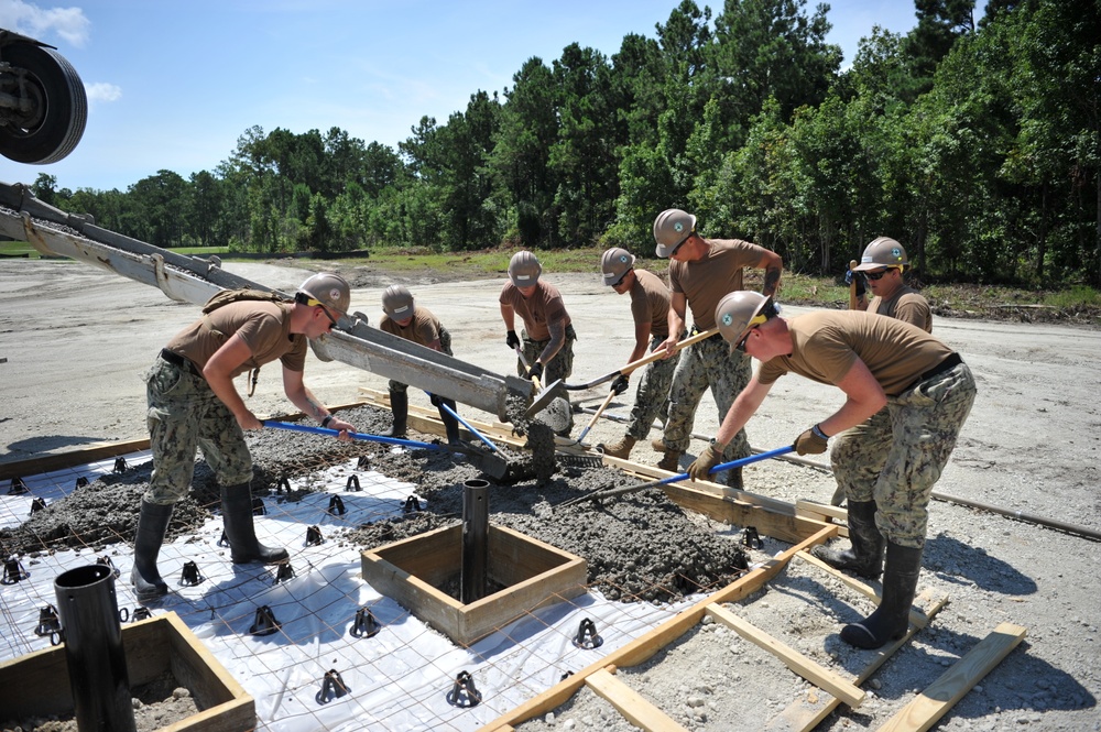 Seabees and Marines place two concrete pads on board Marine Corps Base Camp Lejeune, NC