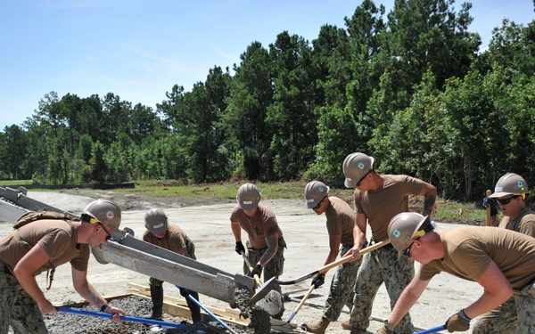 Seabees and Marines place two concrete pads on board Marine Corps Base Camp Lejeune, NC