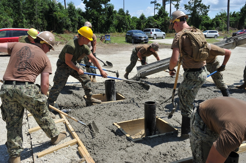 Seabees and Marines place two concrete pads on board Marine Corps Base Camp Lejeune, NC