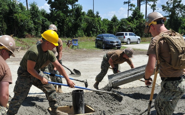 Seabees and Marines place two concrete pads on board Marine Corps Base Camp Lejeune, NC