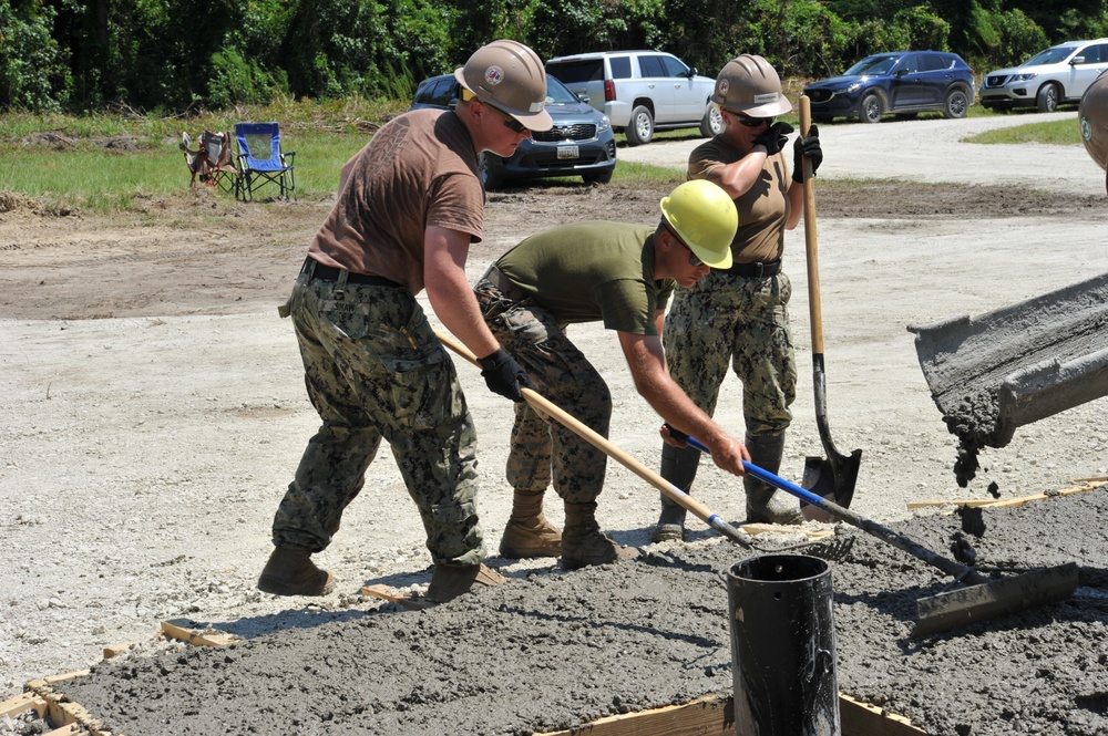 Seabees and Marines place two concrete pads on board Marine Corps Base Camp Lejeune, NC