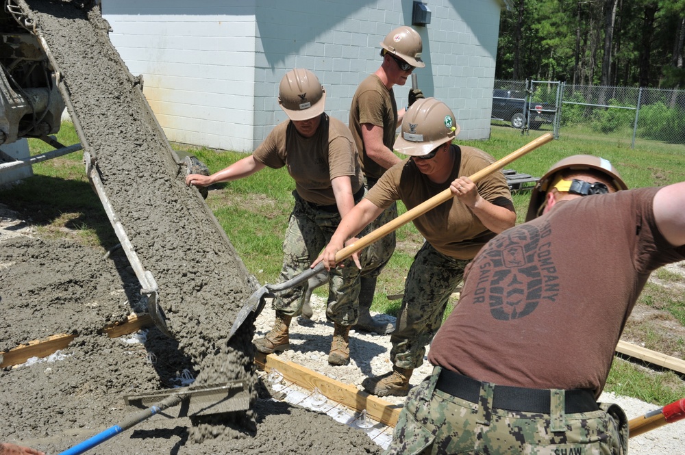 Seabees and Marines place two concrete pads on board Marine Corps Base Camp Lejeune, NC