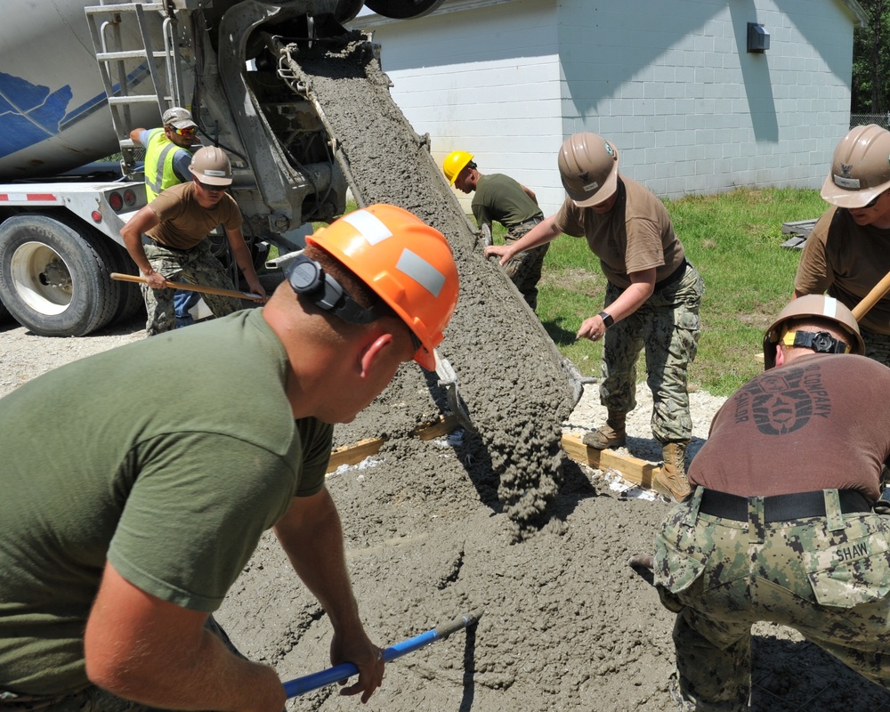 Seabees and Marines place two concrete pads on board Marine Corps Base Camp Lejeune, NC