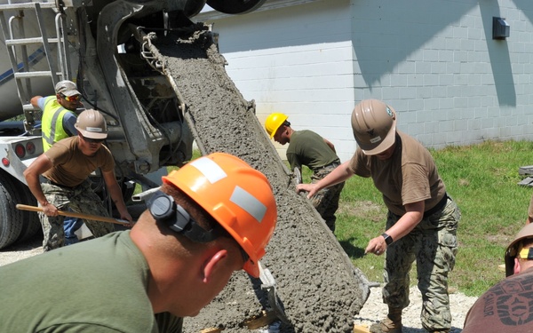 Seabees and Marines place two concrete pads on board Marine Corps Base Camp Lejeune, NC