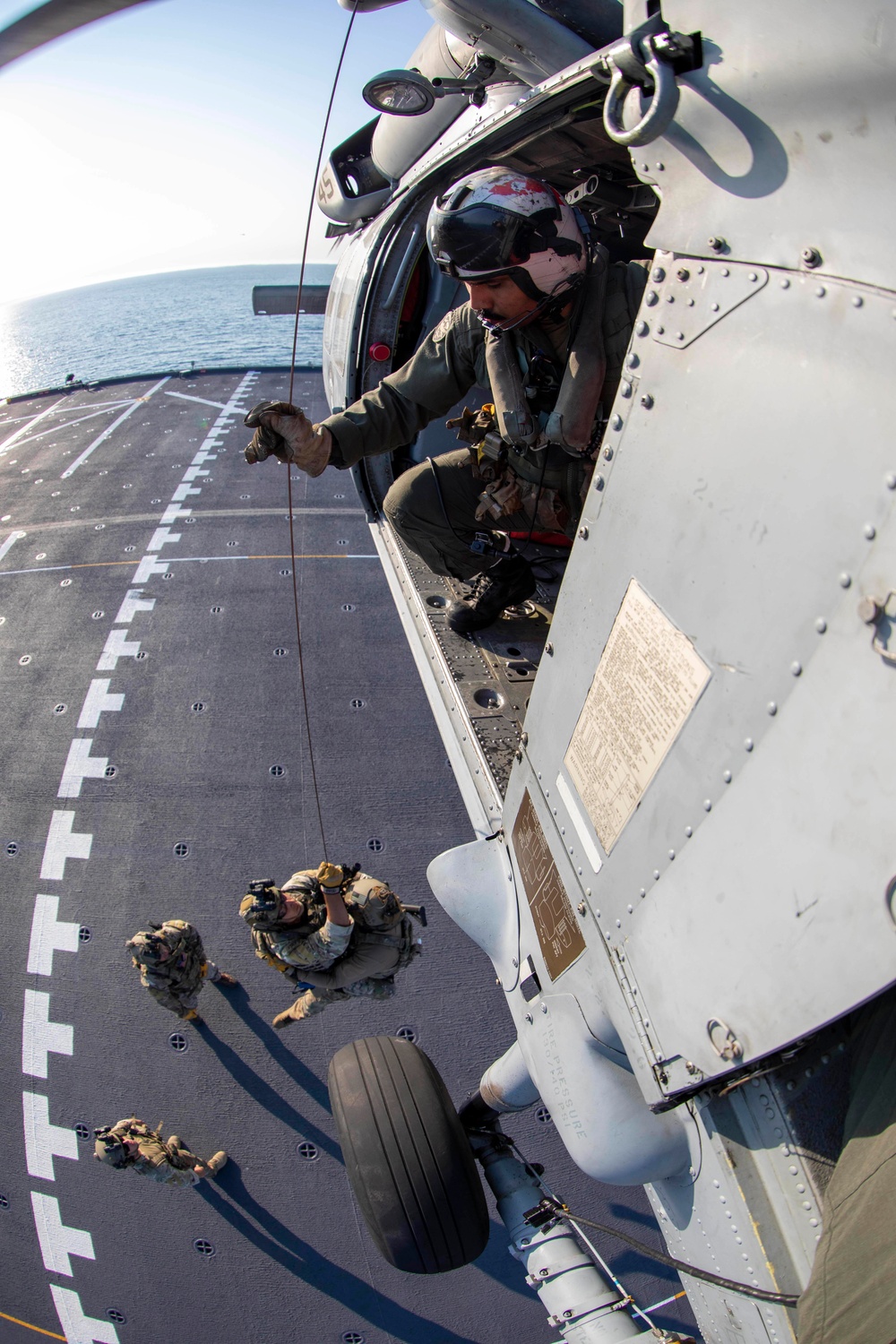 AWS3 Rafael Benavides from HSC 23 hoists MSRT members in an MH-60S Sea Hawk
