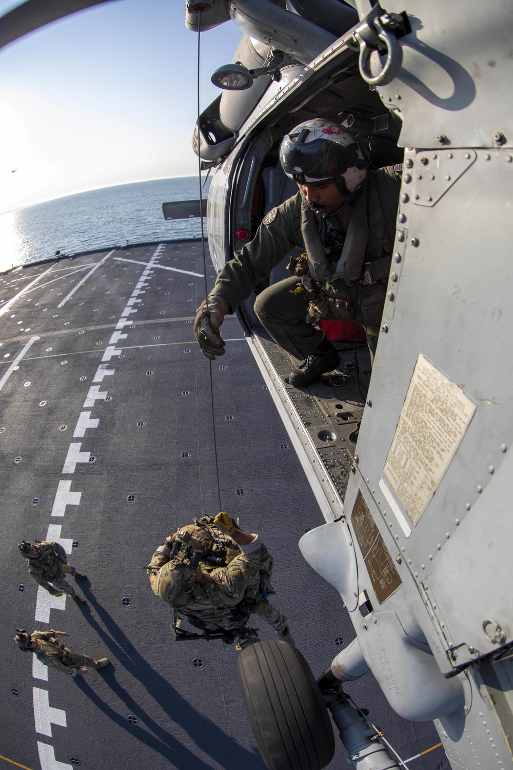 AWS3 Rafael Benavides from HSC 23 hoists MSRT members in an MH-60S Sea Hawk