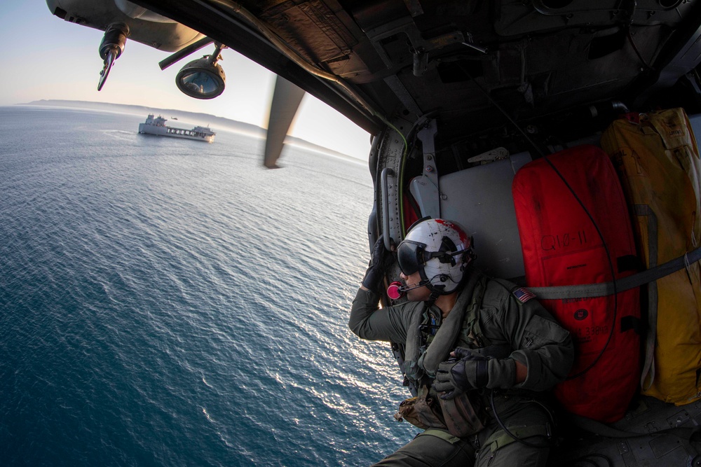 AWS3 Rafael Benavides from HSC 23 rides in an MH-60S Sea Hawk