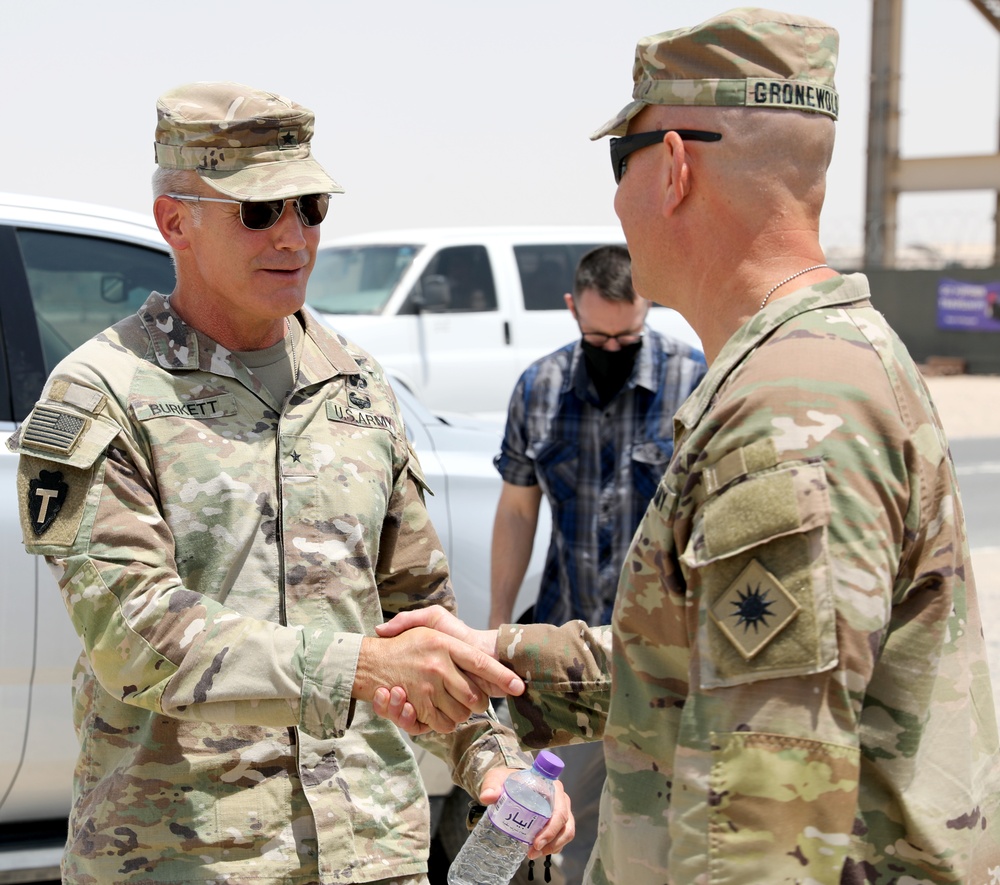 Brig. Gen. Ronald Burkett visits Camp Buehring and coins three Task Force Phoenix Soldiers