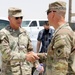 Brig. Gen. Ronald Burkett visits Camp Buehring and coins three Task Force Phoenix Soldiers