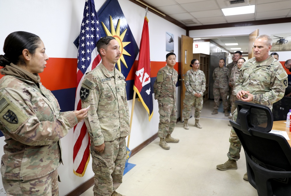 Brig. Gen. Ronald Burkett visits Camp Buehring and coins three Task Force Phoenix Soldiers