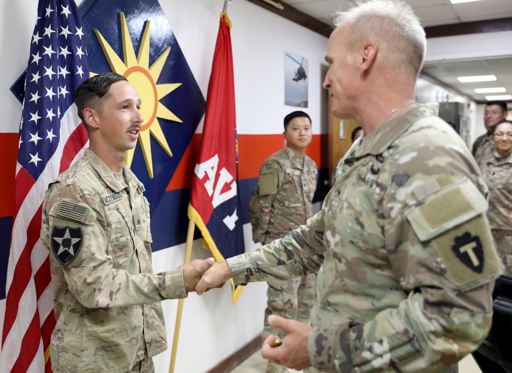 Brig. Gen. Ronald Burkett visits Camp Buehring and coins three Task Force Phoenix Soldiers