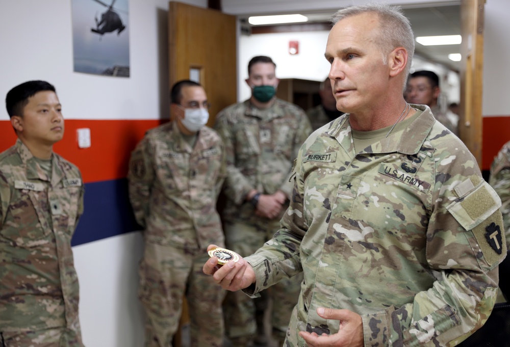 Brig. Gen. Ronald Burkett visits Camp Buehring and coins three Task Force Phoenix Soldiers