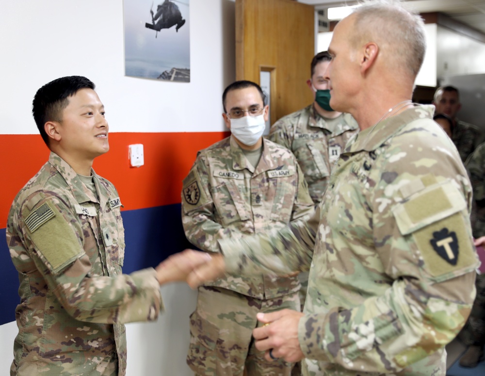 Brig. Gen. Ronald Burkett visits Camp Buehring and coins three Task Force Phoenix Soldiers